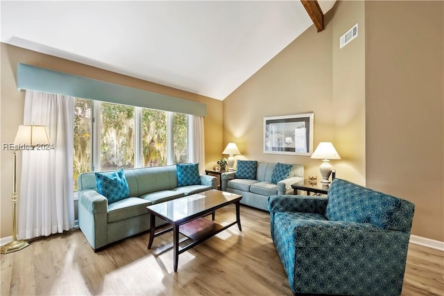 living room with hardwood / wood-style floors and lofted ceiling with beams