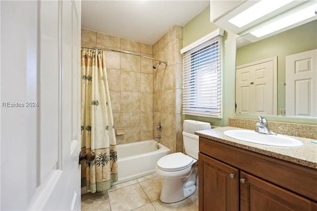 full bathroom featuring vanity, shower / bathtub combination with curtain, tile patterned floors, and toilet