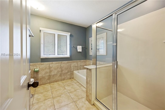 bathroom with tile patterned floors and independent shower and bath