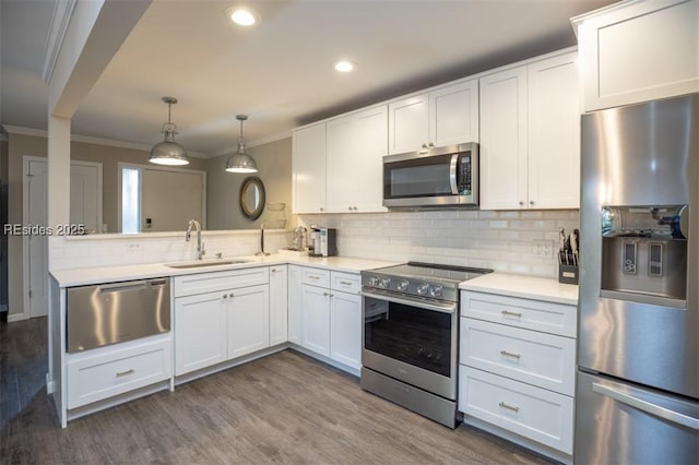 kitchen with white cabinetry, stainless steel appliances, sink, and pendant lighting