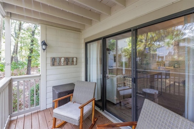 sunroom with beamed ceiling and plenty of natural light