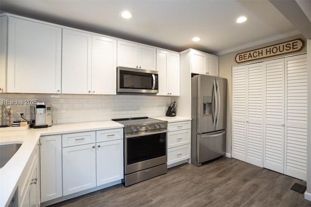 kitchen featuring white cabinetry, appliances with stainless steel finishes, dark hardwood / wood-style flooring, and decorative backsplash