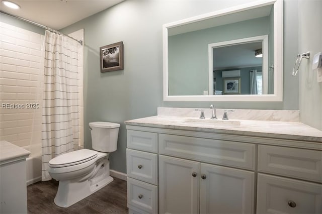 full bathroom featuring toilet, wood-type flooring, shower / bathtub combination with curtain, and vanity