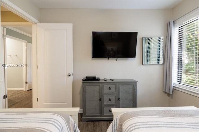 bedroom with multiple windows, crown molding, and dark hardwood / wood-style floors