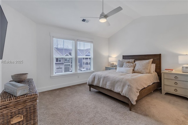 bedroom with vaulted ceiling, light colored carpet, and ceiling fan