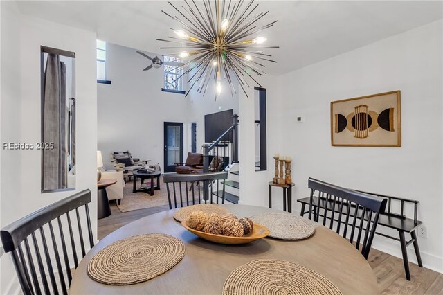 dining space featuring light wood-type flooring and a notable chandelier