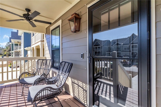 balcony with covered porch and ceiling fan