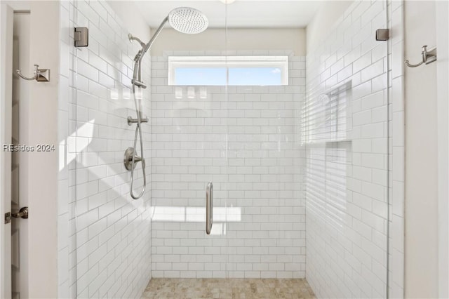 bathroom featuring a shower with door