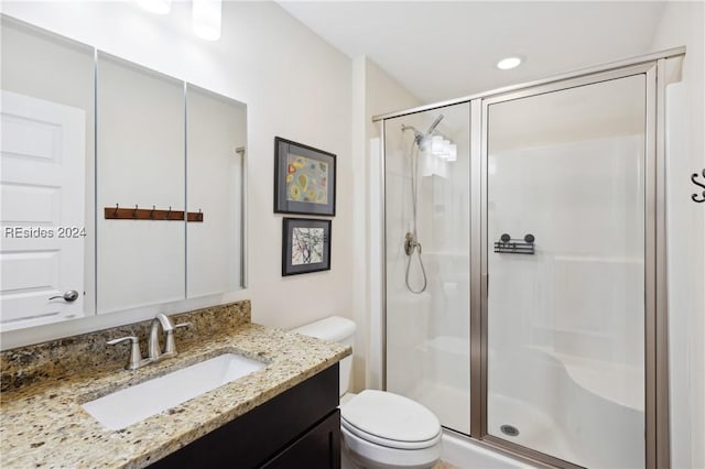 bathroom featuring vanity, toilet, and walk in shower