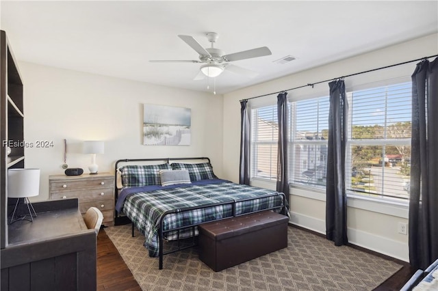 bedroom with dark wood-type flooring and ceiling fan