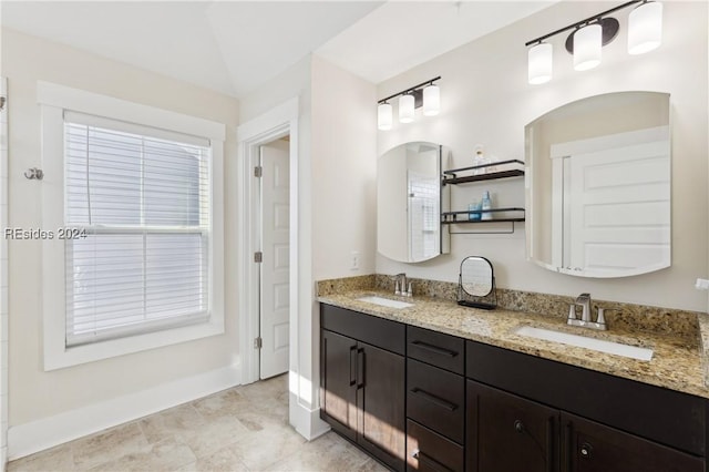 bathroom with vanity and vaulted ceiling