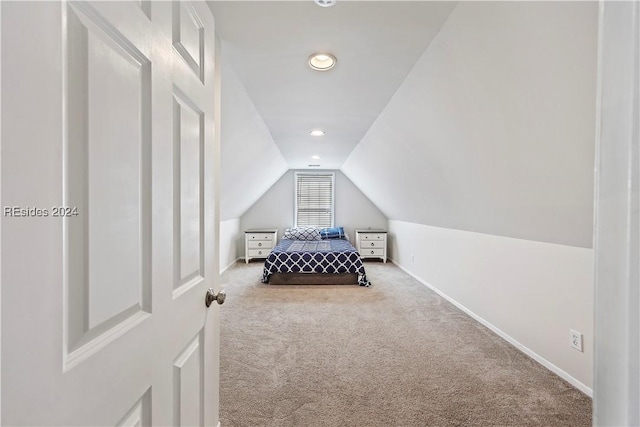 carpeted bedroom featuring lofted ceiling