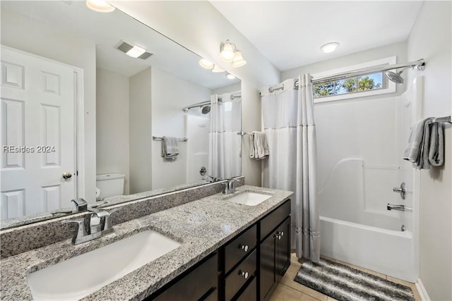 full bathroom with shower / bath combo, vanity, tile patterned floors, and toilet