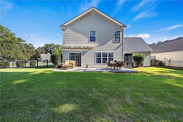 back of house featuring a patio area and a lawn