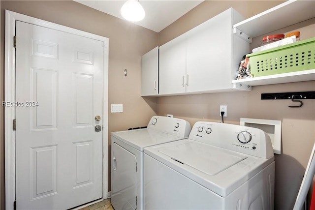 washroom featuring cabinets and washer and dryer