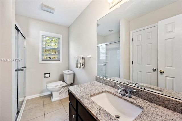 bathroom with vanity, an enclosed shower, tile patterned floors, and toilet