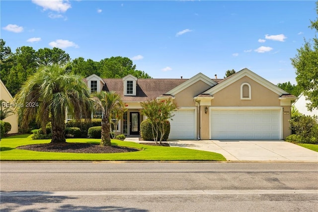 view of front facade with a garage and a front yard