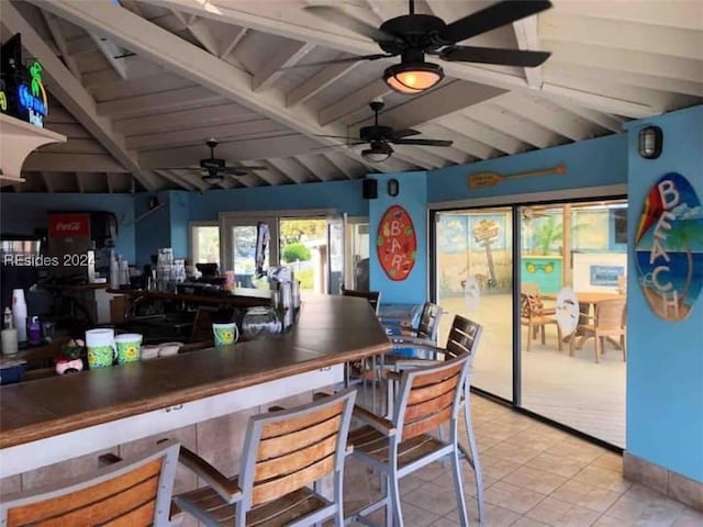 bar featuring light tile patterned flooring, ceiling fan, and beamed ceiling