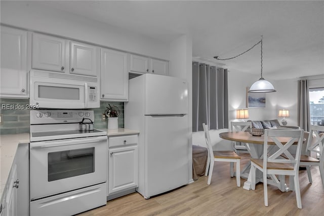 kitchen with pendant lighting, white appliances, white cabinetry, decorative backsplash, and light wood-type flooring