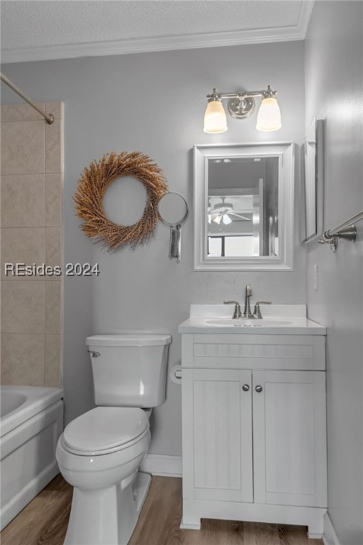 full bathroom with vanity, hardwood / wood-style floors, ornamental molding, and toilet