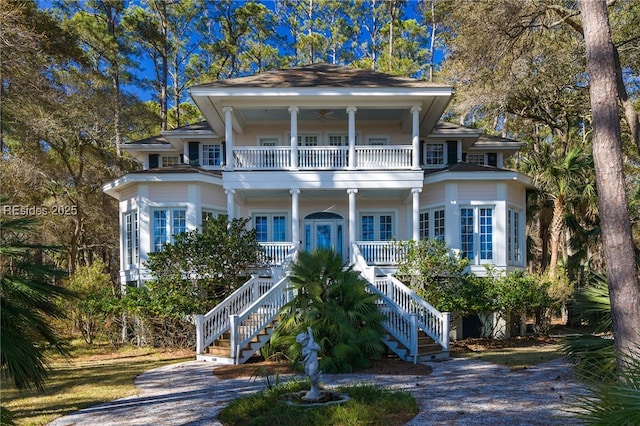 view of front of home with ceiling fan, a balcony, and covered porch