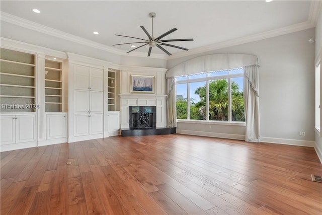 unfurnished living room with ornamental molding, wood-type flooring, and ceiling fan