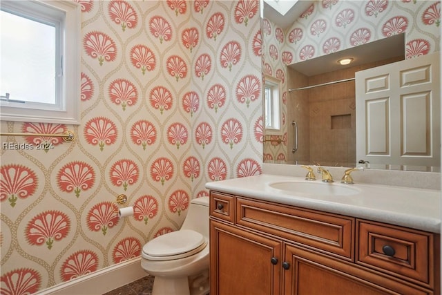 bathroom with vanity, tile patterned flooring, a skylight, and toilet