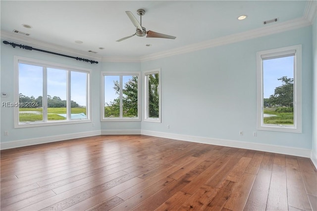 empty room with crown molding, ceiling fan, and hardwood / wood-style flooring