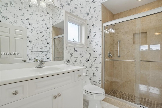 bathroom featuring vanity, tile patterned floors, a shower with door, and toilet