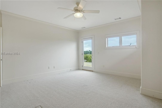 carpeted spare room with crown molding and ceiling fan