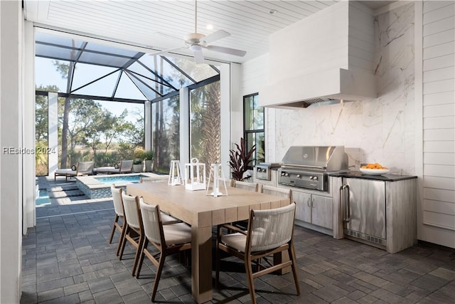 view of patio / terrace featuring exterior kitchen, a lanai, area for grilling, and ceiling fan