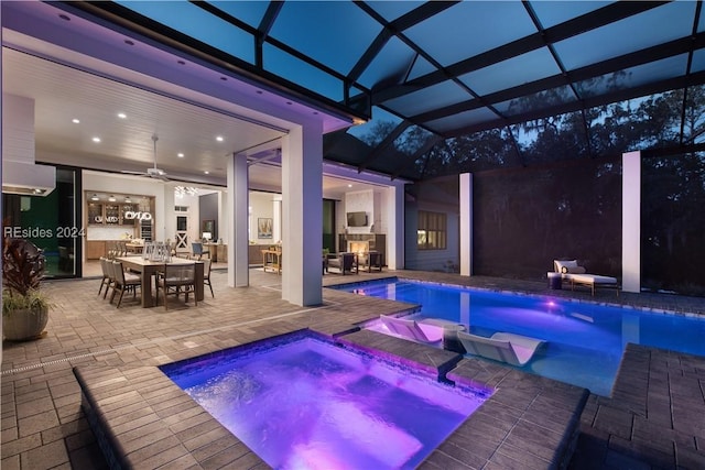 view of pool with an in ground hot tub, area for grilling, and a patio