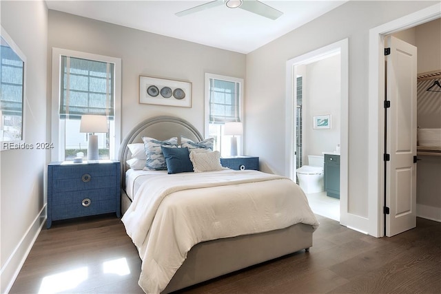 bedroom with dark hardwood / wood-style floors, ceiling fan, and connected bathroom