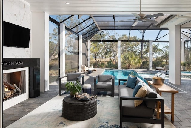 sunroom / solarium with ceiling fan and a high end fireplace