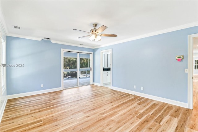 empty room featuring crown molding, light hardwood / wood-style floors, and ceiling fan