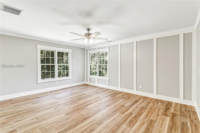 empty room featuring crown molding, ceiling fan, and light hardwood / wood-style floors