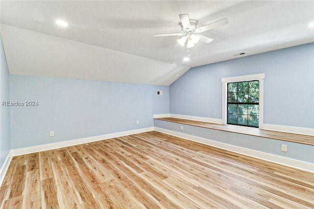 additional living space with lofted ceiling, light hardwood / wood-style flooring, and ceiling fan