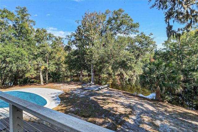 view of pool featuring a water view