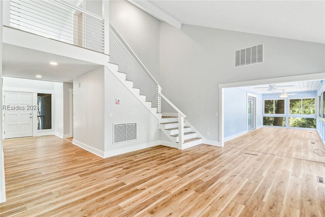 interior space featuring high vaulted ceiling and light wood-type flooring