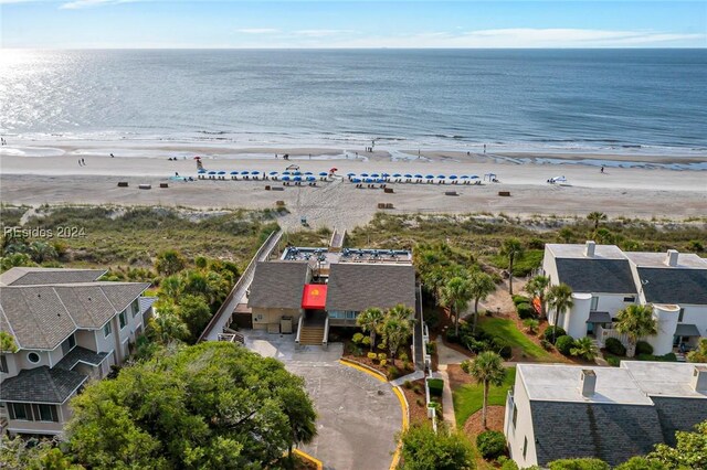 bird's eye view featuring a water view and a beach view