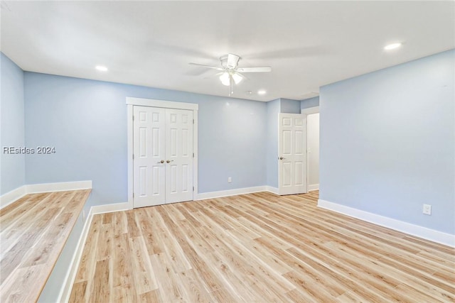 empty room featuring ceiling fan and light hardwood / wood-style flooring