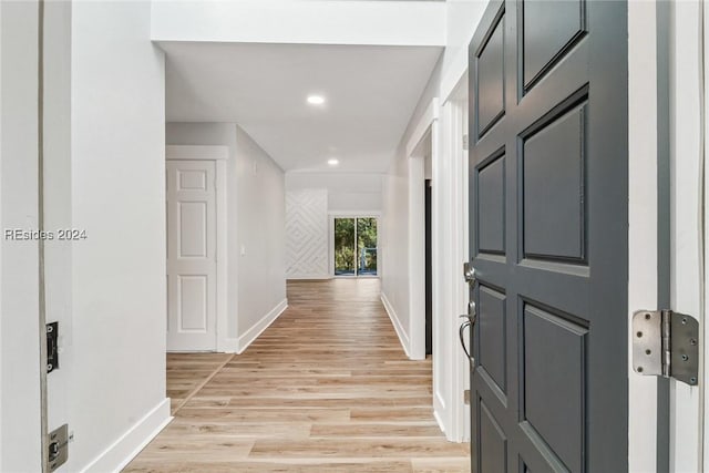 hall with light hardwood / wood-style floors