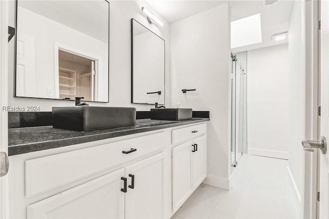 bathroom with tile patterned flooring and vanity