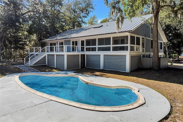 back of property with a sunroom