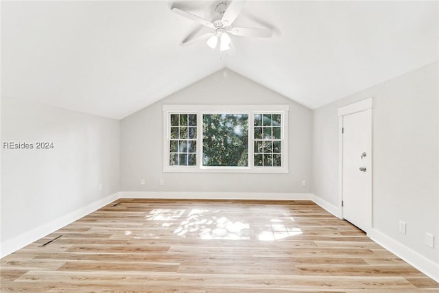 additional living space with ceiling fan, lofted ceiling, and light wood-type flooring