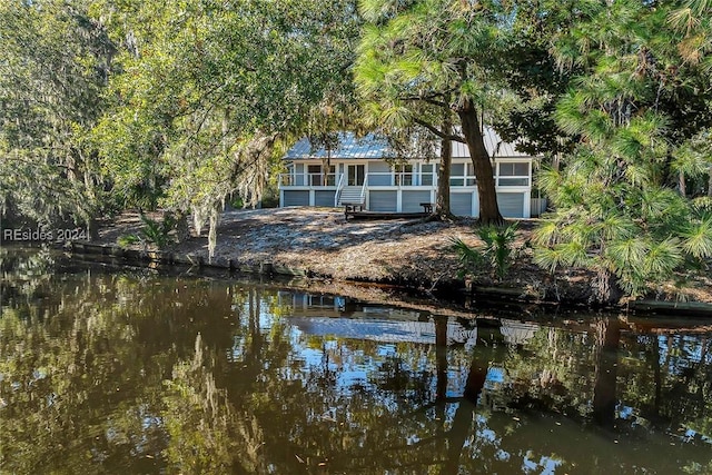 back of property featuring a water view