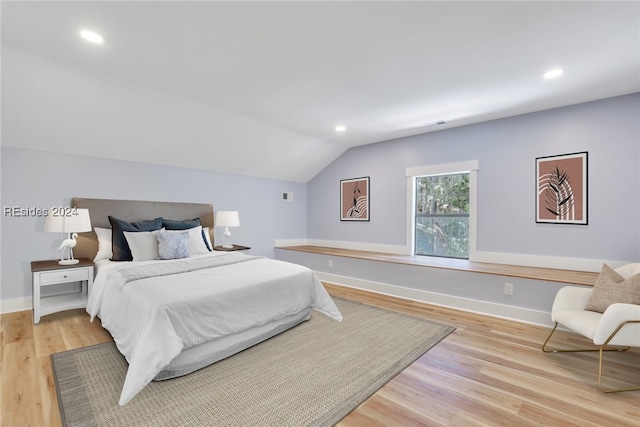 bedroom featuring vaulted ceiling and light hardwood / wood-style flooring