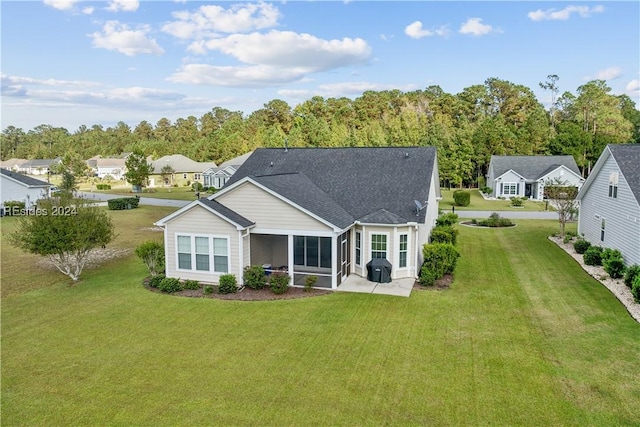 rear view of property featuring a yard and a patio area