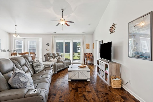 living room featuring dark hardwood / wood-style flooring, lofted ceiling, and ceiling fan