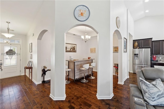 entryway with dark hardwood / wood-style flooring and vaulted ceiling